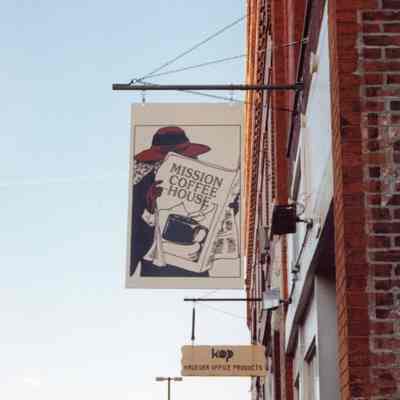 The Mission Coffee House street sign during the day