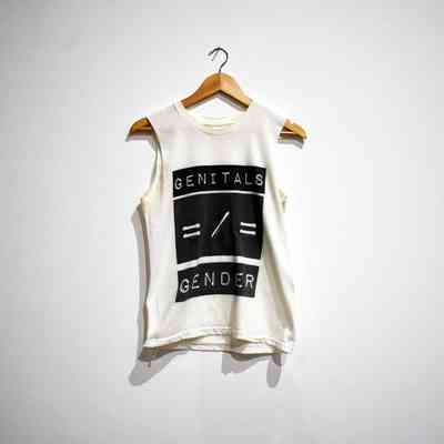 White t-shirt with sleeves cut off. Three black boxes on the front with white text reading "Genitals" "=/=" "Gender"