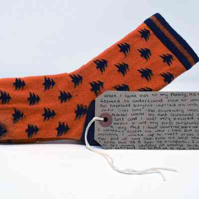 Orange socks with navy blue tips, heels, top hems, and tree pattern.