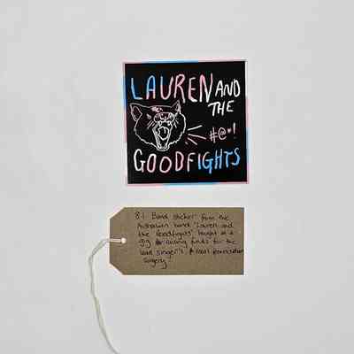 The image shows a band sticker alongside a handwritten tag describing its significance and origin.