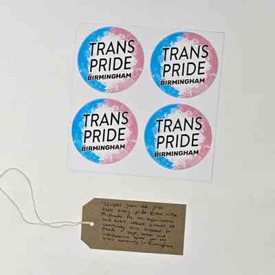 Sheet of 4 stickers in trans pride colours reading "TRANS PRIDE BIRMINGHAM". Underneath is a tag reading "Stickers from the first ever trans pride event in the Midlands. As an organisation and event without finances, the community came together to provide a safe, sober and intersectional space for the trans community in Birmingham."