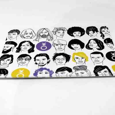 Triangular scarf laying on a wooden surface with point at the bottom. Across the top of the scarf is a black stripe with white block text reading "IF WE ARE NOT VISIBLE WE CANNOT DEMAND THE WORLD MAKE SPACE." The rest of the scarf shows 4 rows of simple line-art drawings of various faces, occassionally interspersed with the non-binary symnol on purple and yellow circles.