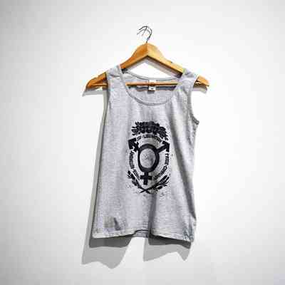 A grey tank top printed in black with the trans symbol surrounded by the words STRENGTH AUTONOMY JOY LIBERATION PRIDE COMMUNITY and floral motifs, on a wooden hanger.