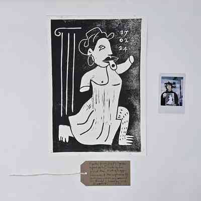 The image shows a black and white artwork with a date, alongside a small instant photo.