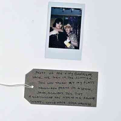 A photo displays two people in costumes at a Halloween party, accompanied by a heartfelt handwritten note.