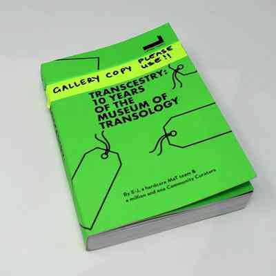 The image shows a green book titled "Transcestry: 10 Years of the Museum of Transology".