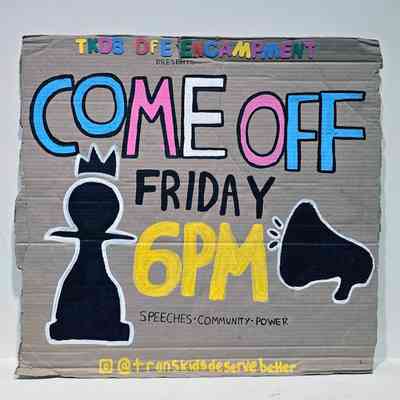 A hand drawn cardboard Trans Kids Deserve Better placard with text "COME OFF FRIDAY 6PM - SPEECHES COMMUNITY POWER" in blue, white, pink, black and yellow text. It also features the silhouette of a pawn and a megaphone.