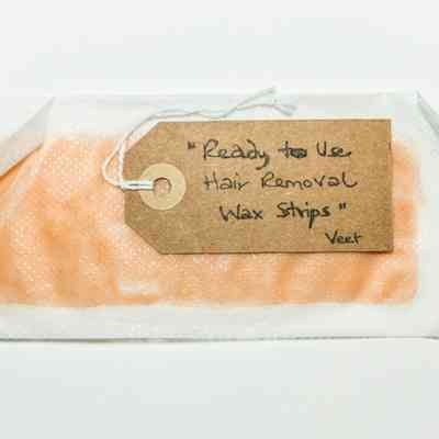 2 sheets of plastic with pink wax inbetween. Edges have curled up on covers, strip has curved up & down at one end.