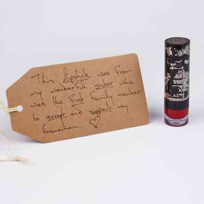 Black lipstick tube. Some of the black paint has been stripped away revealing silver underneath.