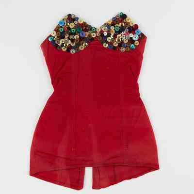 The red dress features a bust adorned with colorful, decorative buttons, giving it a unique and festive look.