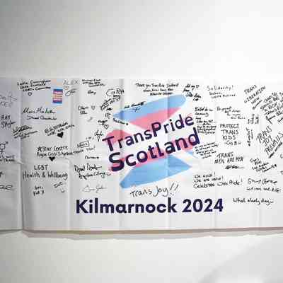 A long white vanner which is from the Trans Pride Scotland 2024 and is covered in writing and signatures.