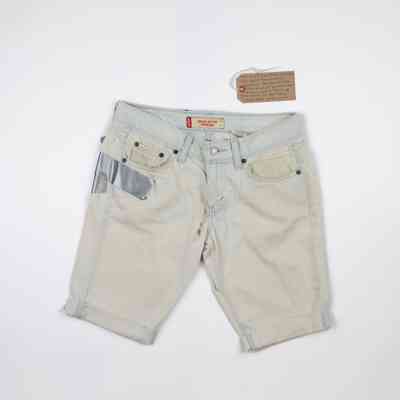 Front of a pair of white shorts with the cuffs rolled up. There is a small tear next to the fly of the shorts and duct tape visible on the right hand side which is wrapping around from the back of the shorts.