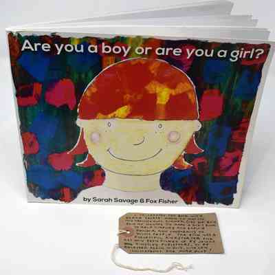 Paperback book with the title "Are you a boy or a girl?" by Sarah Savage & Fox Fisher. The cover shows a simple line drawing of a person with pink hair infront of a dark green, blue, and pink background.