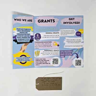 Trans Aid Cymru flyer deatailing the services on offer. With a brown handwritten luggage tag.