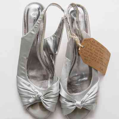Silver open-toed shoes with soles reading "43/10 Emilio Luca X".