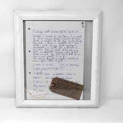 Diary entry written in blue ink, in a white frame, with a tag lying on the bottom right corner. Tag reads: "Diary Entry. April, 2012.
An Excerpt from my diary, Written Whilst drunk.... this captures my thoughts & feelings during the time I accepted myself, and began my journey....."