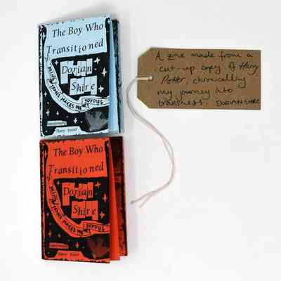 The image shows two zines titled "The Boy Who Transitioned," made using cut-up Harry Potter books.