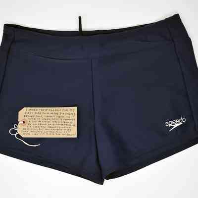 Navy blue "Speedo" swimming trunks with Speedo logo on bottom left leg.
