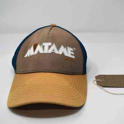 A brown and blue trucker hat displays "MATAKE" with a descriptive tag beside it.