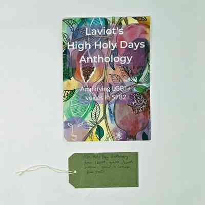Booklet, with a colourful drawn cover of fruits and leaves,  entitled "Laviot's High Holy Days Anthology" " Amplifying LGBT+ voices in 5782". With a brown, handwritten luggage tag.