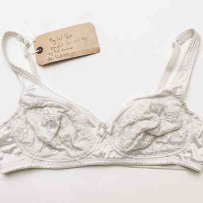 A white bra with lace and embroidered details.