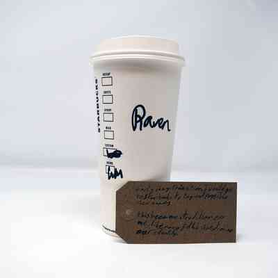 A Starbucks cup labeled "Raven" stands near a handwritten note about identity exploration.