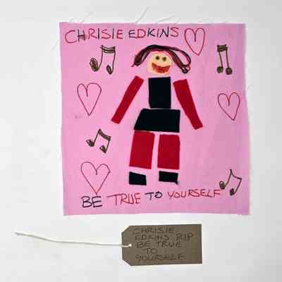 The image shows a colorful drawing with musical notes, hearts, and text saying, "Be true to yourself"