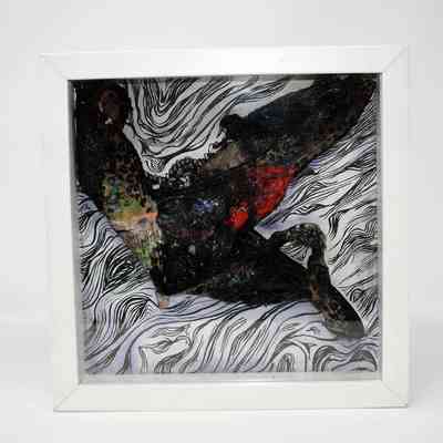 Black underwear covered in various paints and inks mounted on a white background in a white frame. The background has black ink lines drawn horizontally across the top, and swooping round lines moving in loops from the bottom edges, to the center, and back to the edges again.