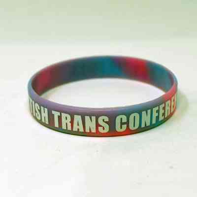 A rubber wristband which is colourful and says 'British Trans Conference'.