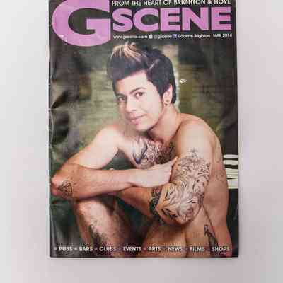 The magazine cover features a tattooed individual sitting and smiling, with "G Scene" prominently displayed above