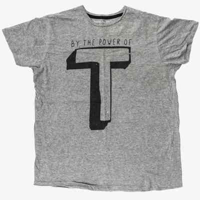 A grey t-shirt with the text "BY THE POWER OF" above a large black "T".