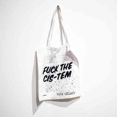 A white tote bag which says 'Fuck The Cis-Tem' on it.