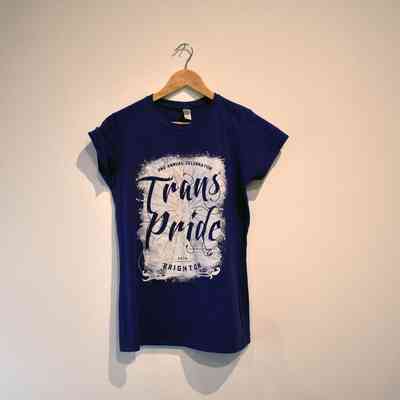 Purple T-shirt with white block and the words "2ND ANNUAL CELEBRATION TRANS PRIDE 2014 BRIGHTON" cut out.