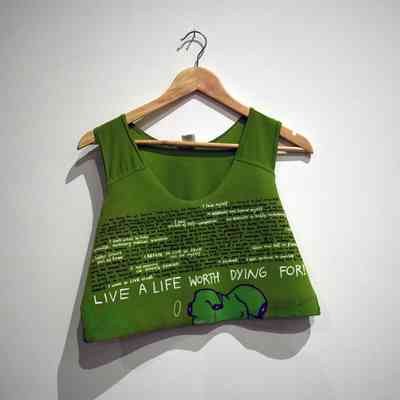 A green binder with handwritten text and illustration hangs on a wooden hanger.