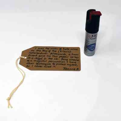 Cylindrical pepper spray canister reading "XA" on a banner and the worders "pepper", "defender of women & men."