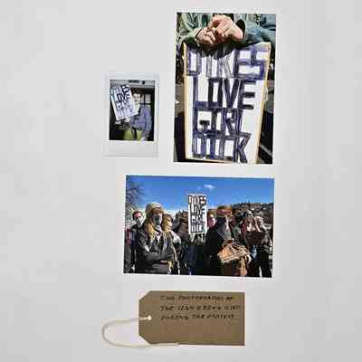 The image shows photographs of a protest, featuring signs supporting LGBTQ+ rights, with visible text.