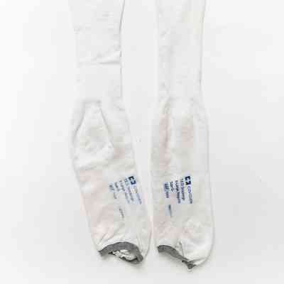 Worn white stockings with grey elastic bottom.