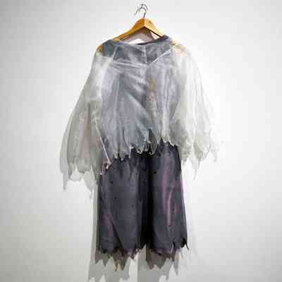 Fancy dress top; white iridescent fine synthetic net fabric, short sleeved, handmade, made in two layers with pointed zig zag edge to hems which are overstitched. Small metal press stud fasteners at neck and back edge, V shaped front neck with press stud. T