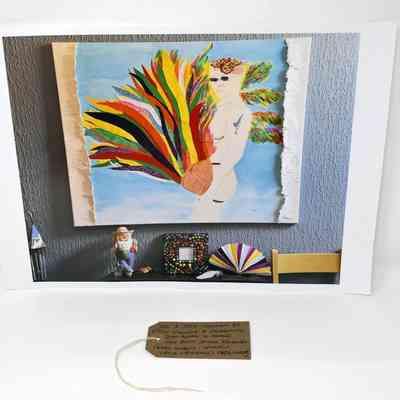 A photograph of an artwork which is hung on the wall with lots of trinkets lined up underneath. The artwork is a self portrait  of a naked person holding what looks like a basket which is bursting with colourful streams,