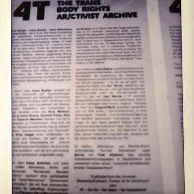 The photograph displays a document titled "The Trans Body Rights Activist Archive" with partially obscured text.