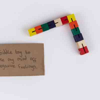 12 colourful cubes linked together by a piece of white elastic thread.