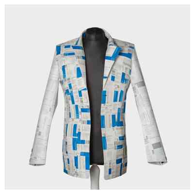 The image shows a mannequin wearing a unique jacket made from variously printed pharmaceutical packaging materials.