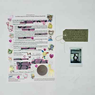 A deed poll letter which has been decorated in stickers and tape covering bits of information.