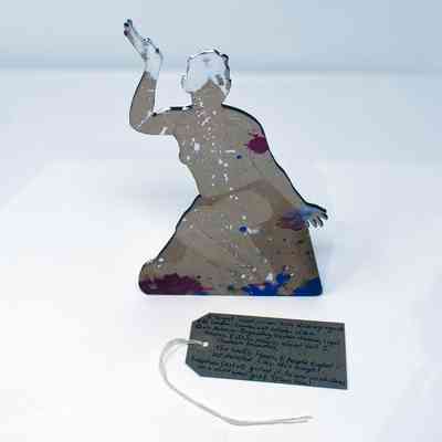 Woodcut portrait with paint splatters and associated tag in whitebox.