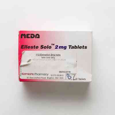 Pink-to-white gradient box reading "MEDA Elleste Solo 2mg Tablets" in black type. There is a prescription label on the bottom left of the front of the box.