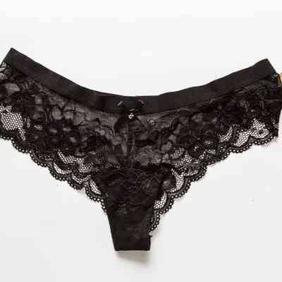 Black lace pants with a brown tag attached to it.