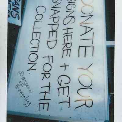 A handwritten sign at Trans Pride Brighton 2022 invites attendees to donate protest signs.