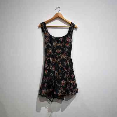 Black sleeveless dress with pink and white flower pattern.