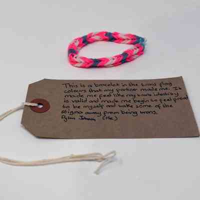 White, pink, and blue bracelet made of loom bands and secured with a plastic "S" clip.