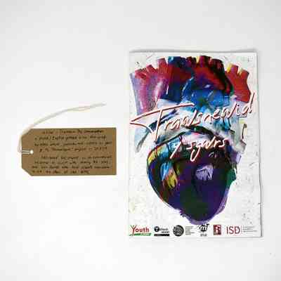 A zine with a colourful cover entitled Trawsnewid y sgwrs (Transform the conversation). With a brown handwritten luggage tag.